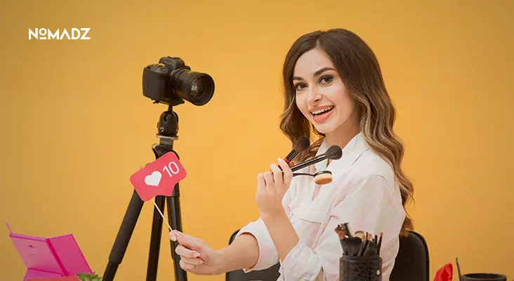 Influencer recording video with camera showing how to work with influencers effectively.