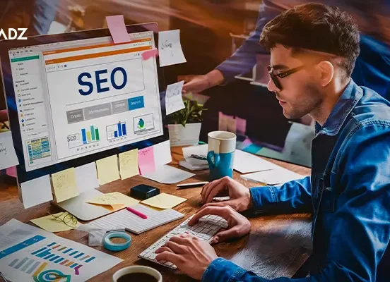 Expert working on Programmatic SEO strategy with analytics dashboard on screen.