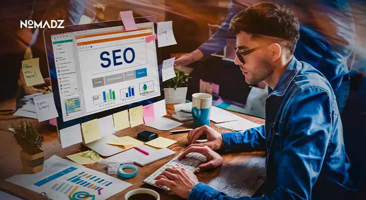 Expert working on Programmatic SEO strategy with analytics dashboard on screen.