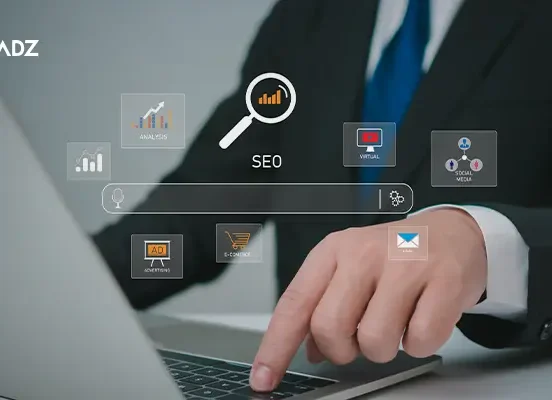 Businessman working on laptop with digital icons representing Search Engine Optimization Techniques.