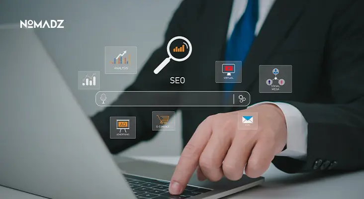 Businessman working on laptop with digital icons representing Search Engine Optimization Techniques.